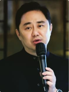 Daniel Jang speaking into a microphone